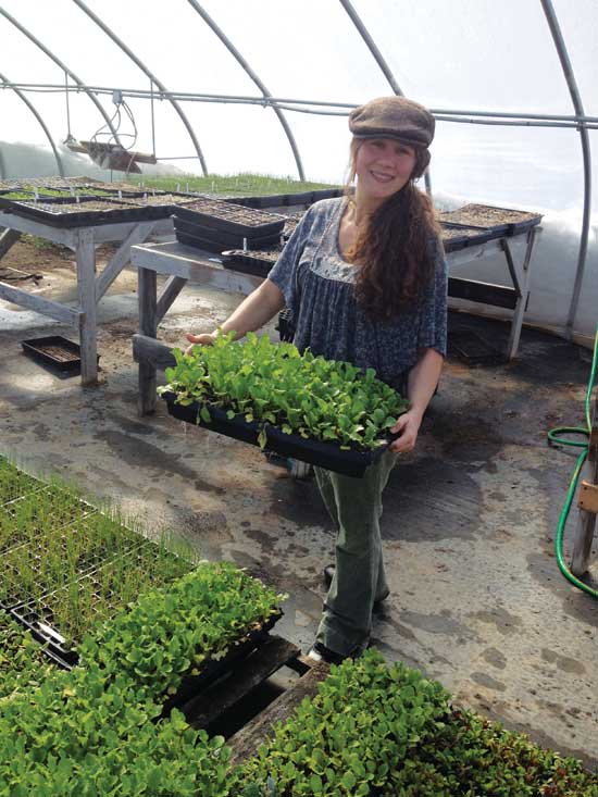 Crystal is all smiles with her lettuce seedlings.